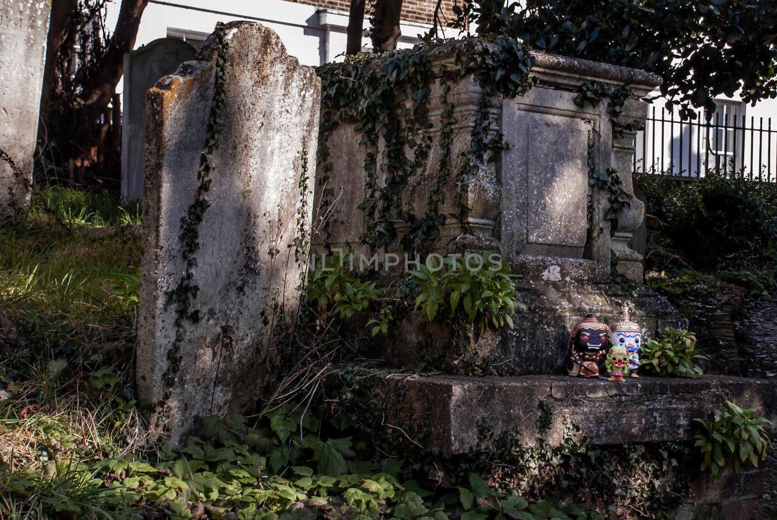 Ravana, Giantess and Hanuman Standing on the grave sign In the cemetery. Traveller doll.