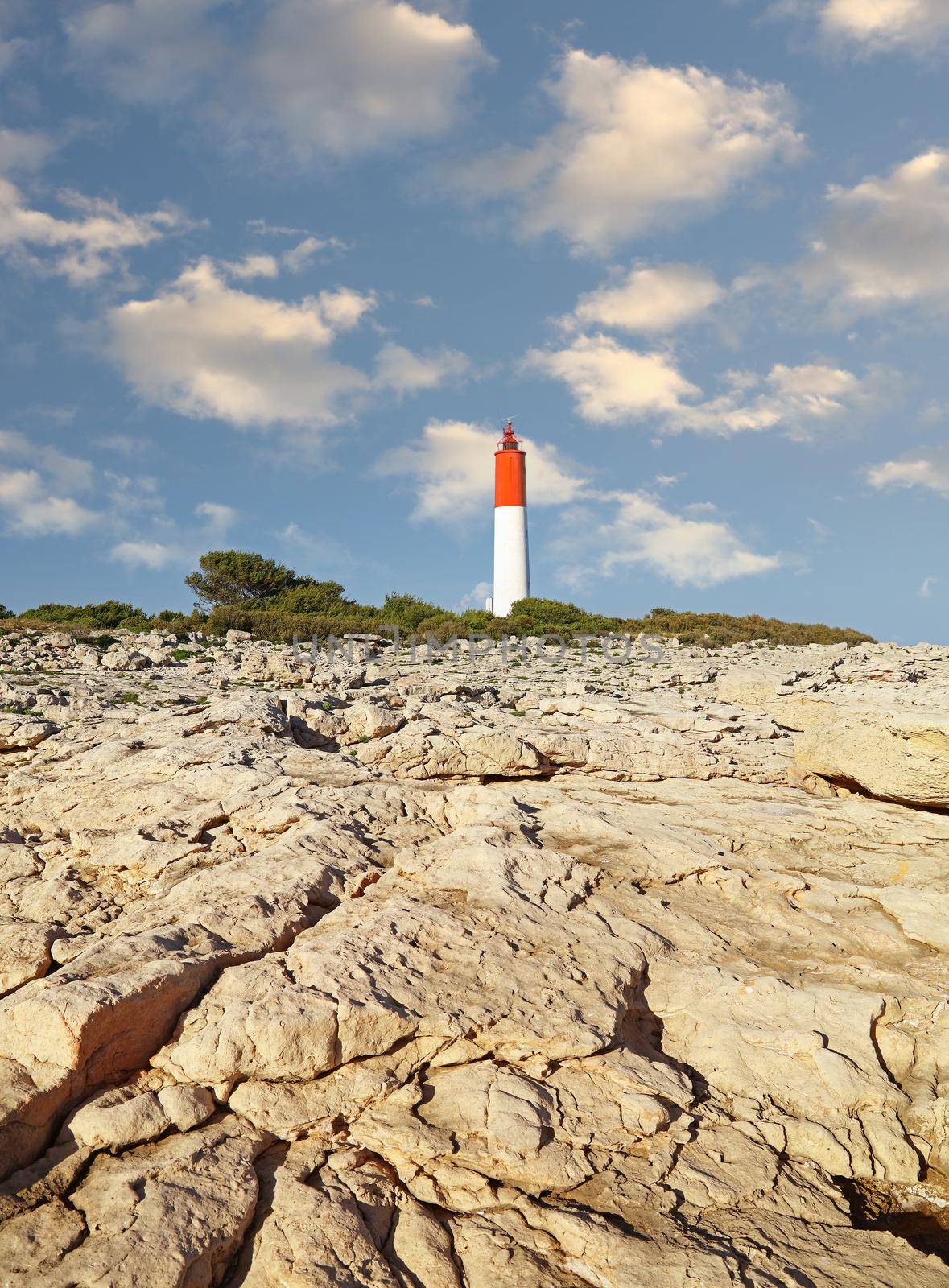 Rocky landscape with lighthouse over clear sky by BreakingTheWalls