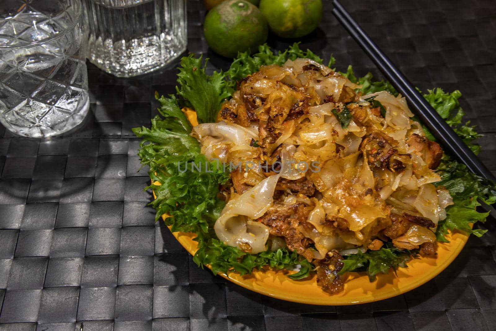 Stir fried flat rice noodle and pork with dark soy sauce. Thai Food. No focus, specifically.