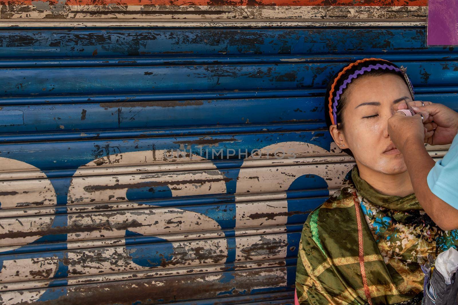 Yaowarat street merchant service customer face hair removal beauty by yarn. by tosirikul