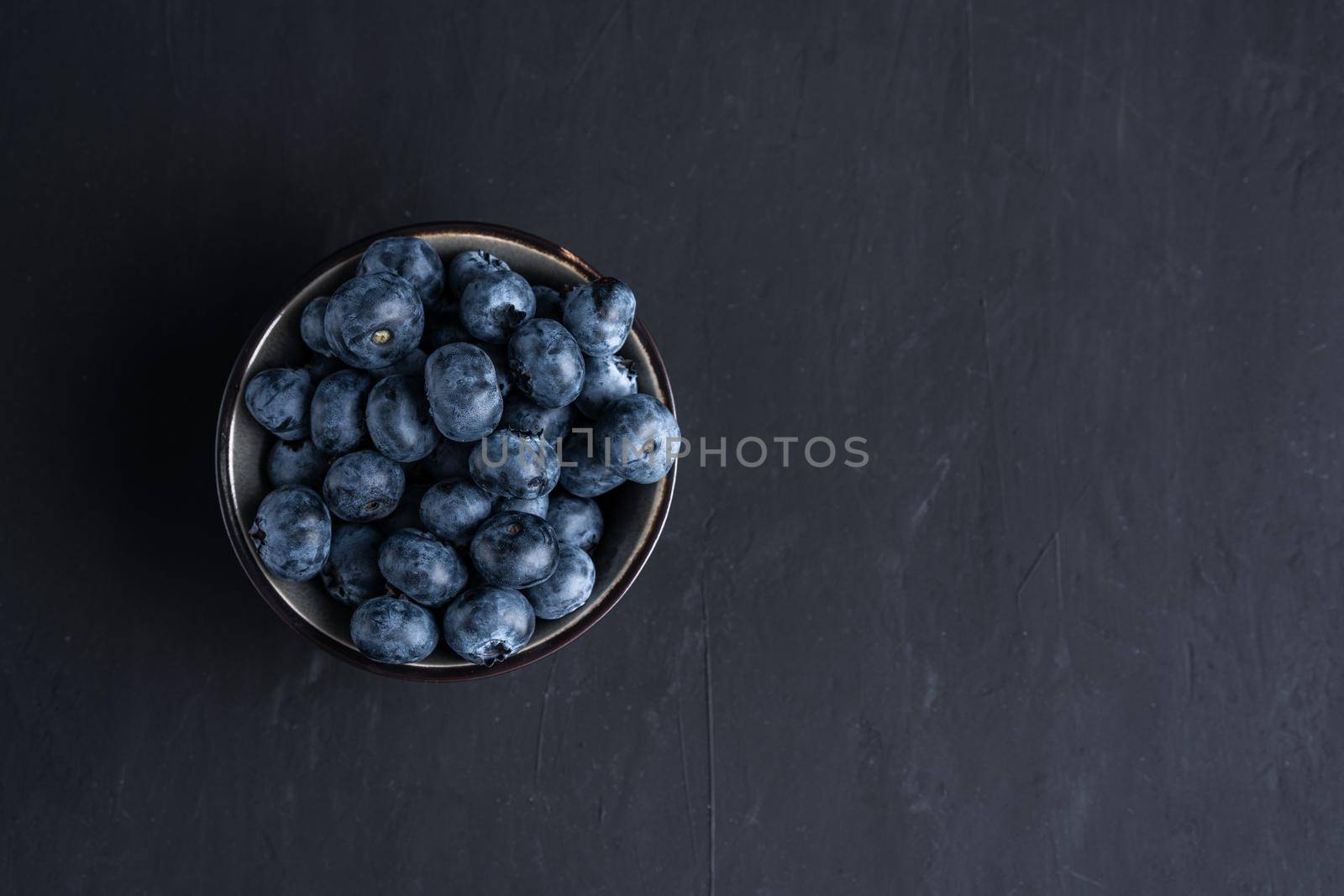 Blueberry antioxidant organic superfood in a bowl concept for healthy eating and dieting nutrition Top view.