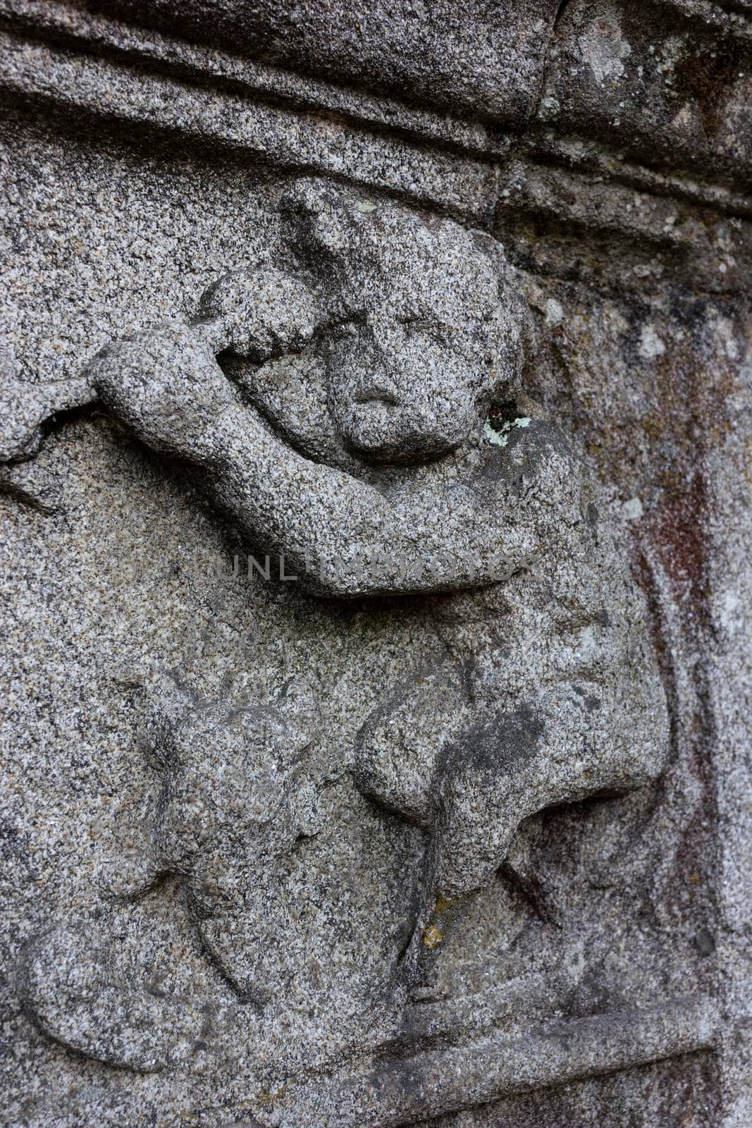 Granite bas-relief worn by the past of the time, in Galicia Spain