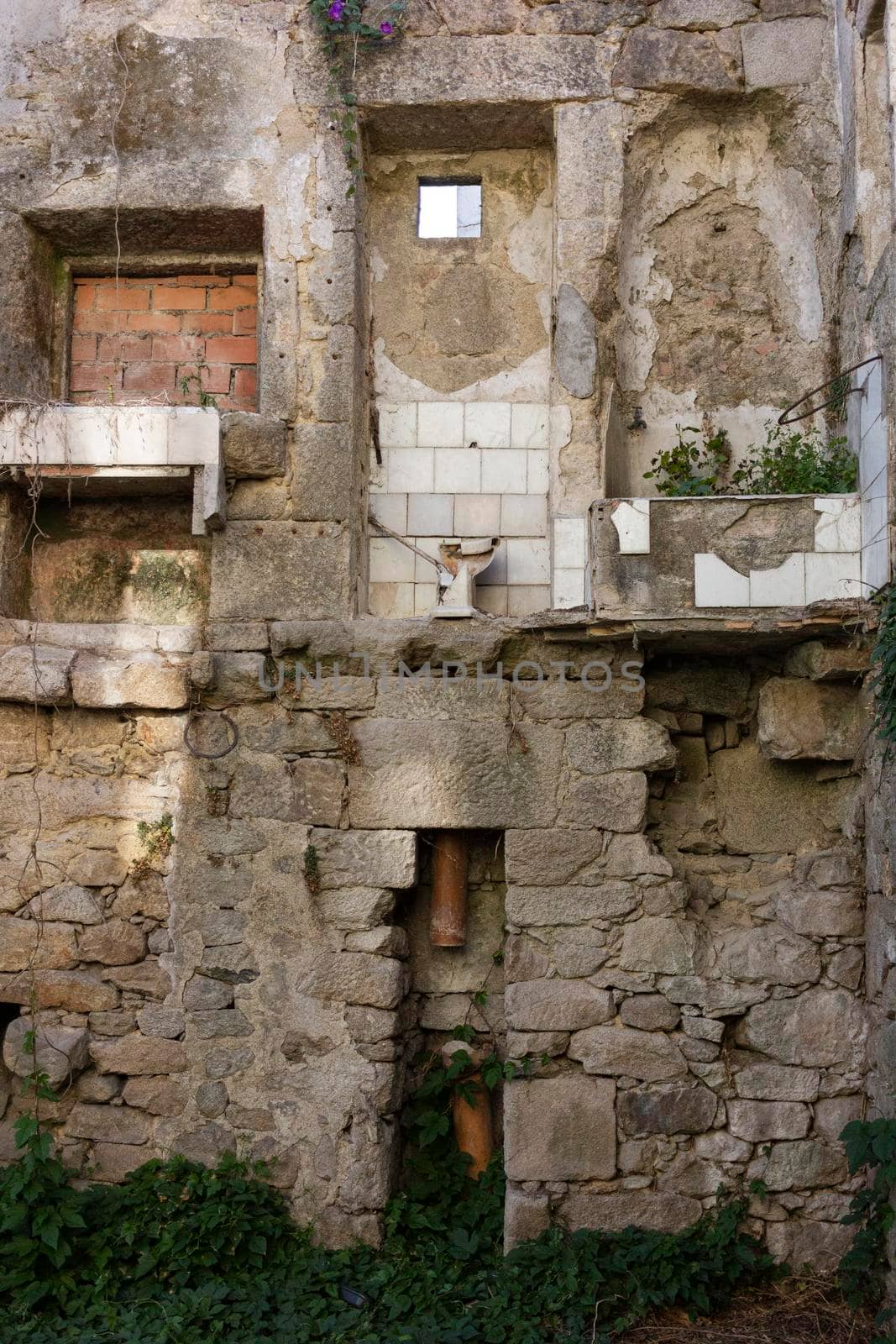 Dilapidated stone house, with exposed toilet by loopneo