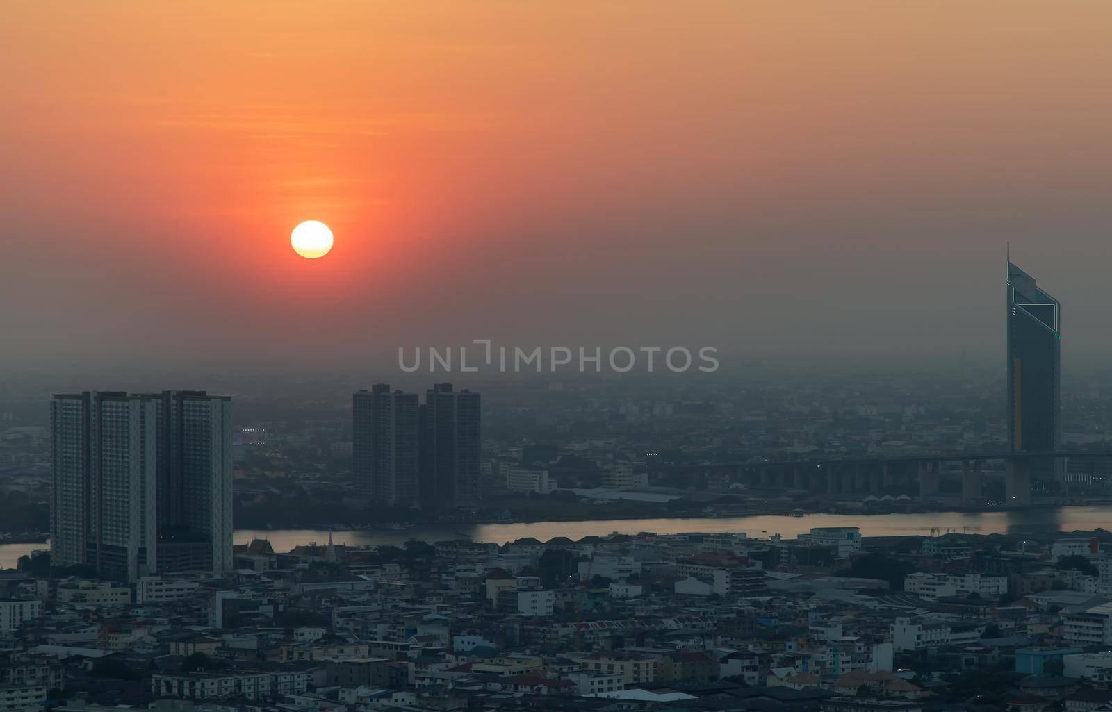 Bangkok, Thailand - Jan 12, 2021 : Aerial view of Amazing beautiful scenery view of Bangkok City skyline and skyscraper before sun setting creates relaxing feeling for the rest of the day. Evening time, Selective focus.