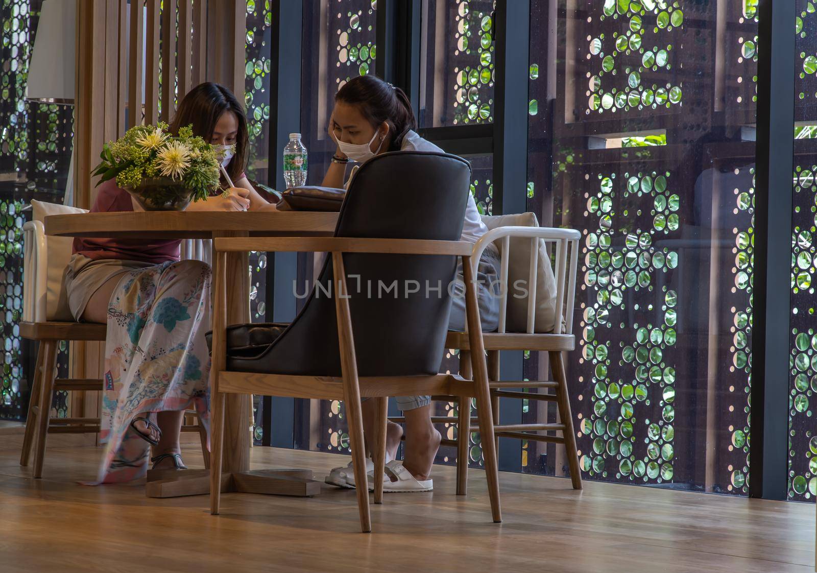 Bangkok, Thailand, Jul 04, 2020 : A meeting of two ladies in co-working space. New normal concept. Selective focus.