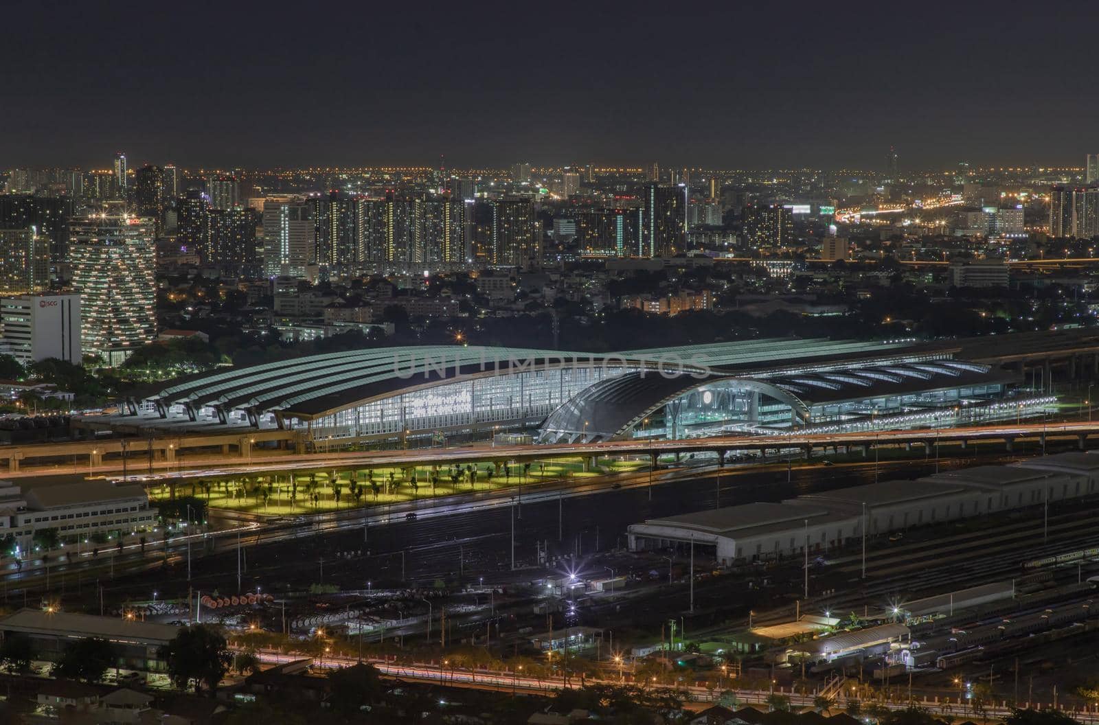 Bangkok, thailand - Aug 28, 2020 : Aerial view of Bang Sue central station with skyscrapers background at night. Selective focus.