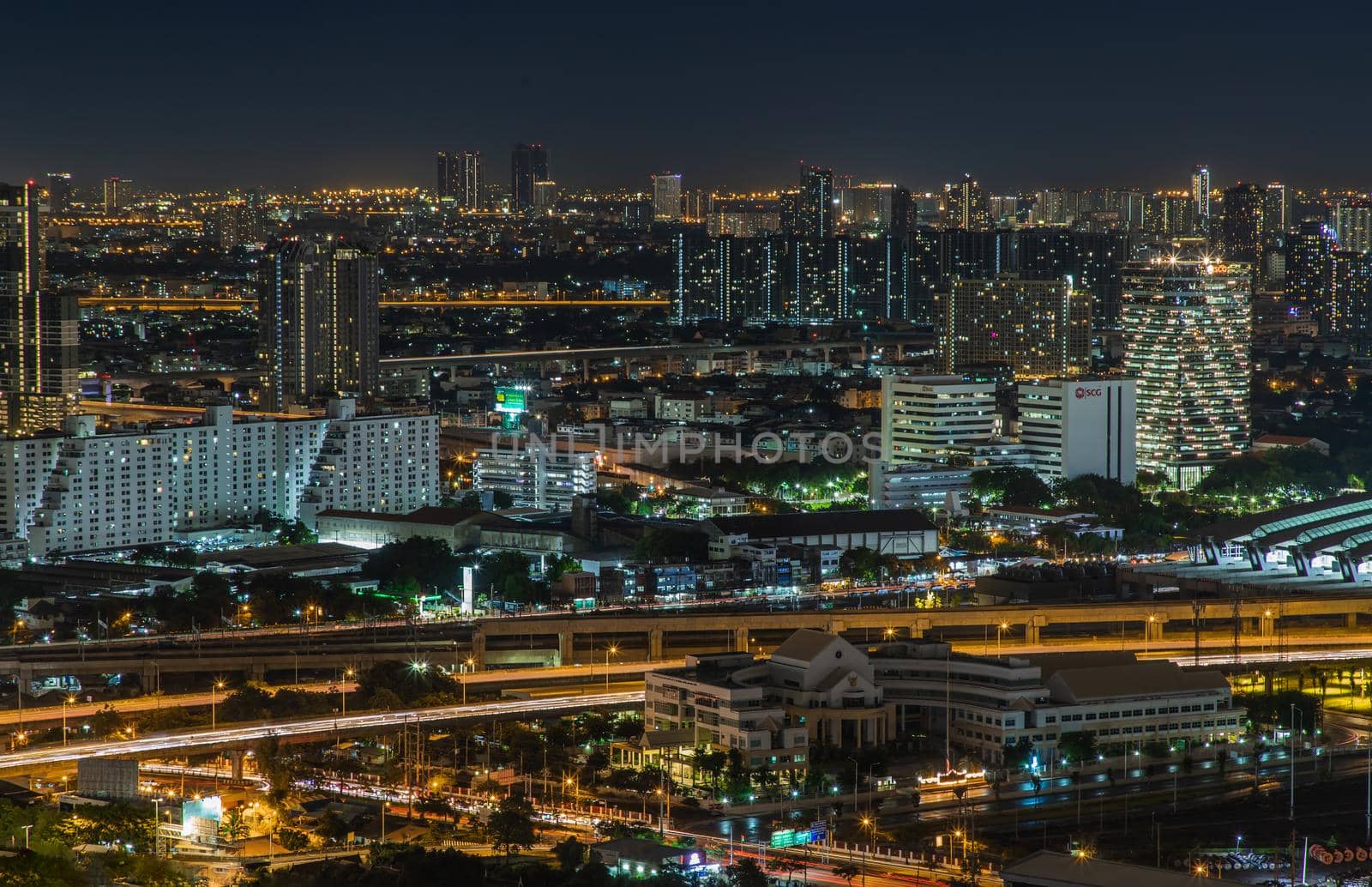 Bangkok, thailand - Aug 28, 2020 : Aerial view of Bang Sue central station with skyscrapers background at night. Selective focus.