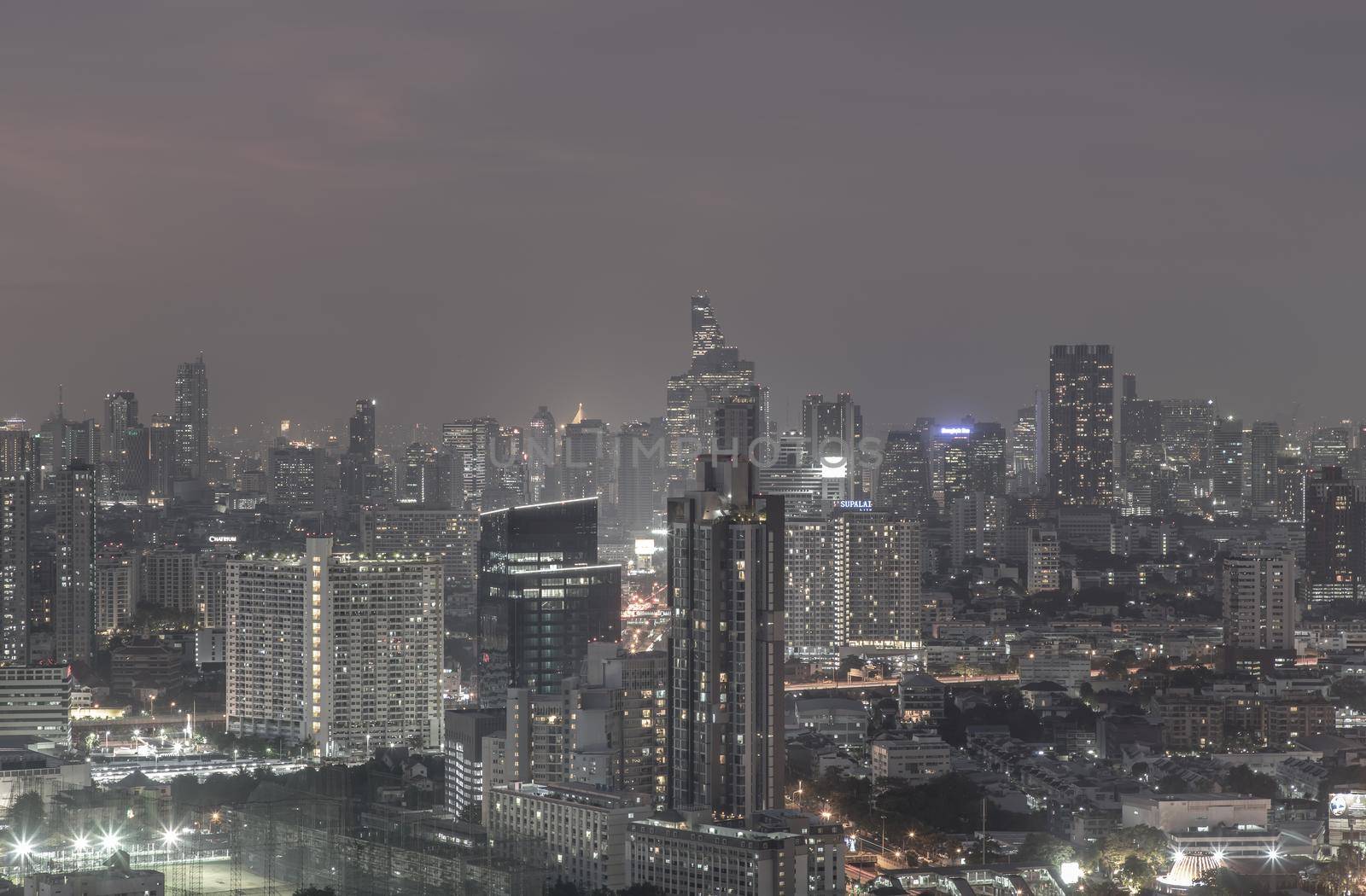 Bangkok, thailand - Dec 23, 2020 : Bangkok downtown cityscape in Business district with bright glowing lights at night give the city a modern style. Dark tone, No focus, specifically.