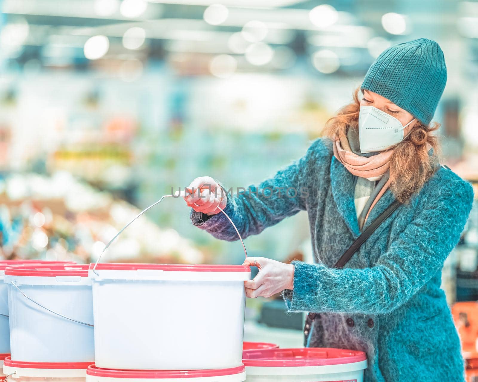 buying paint colors by young woman in the store by Edophoto