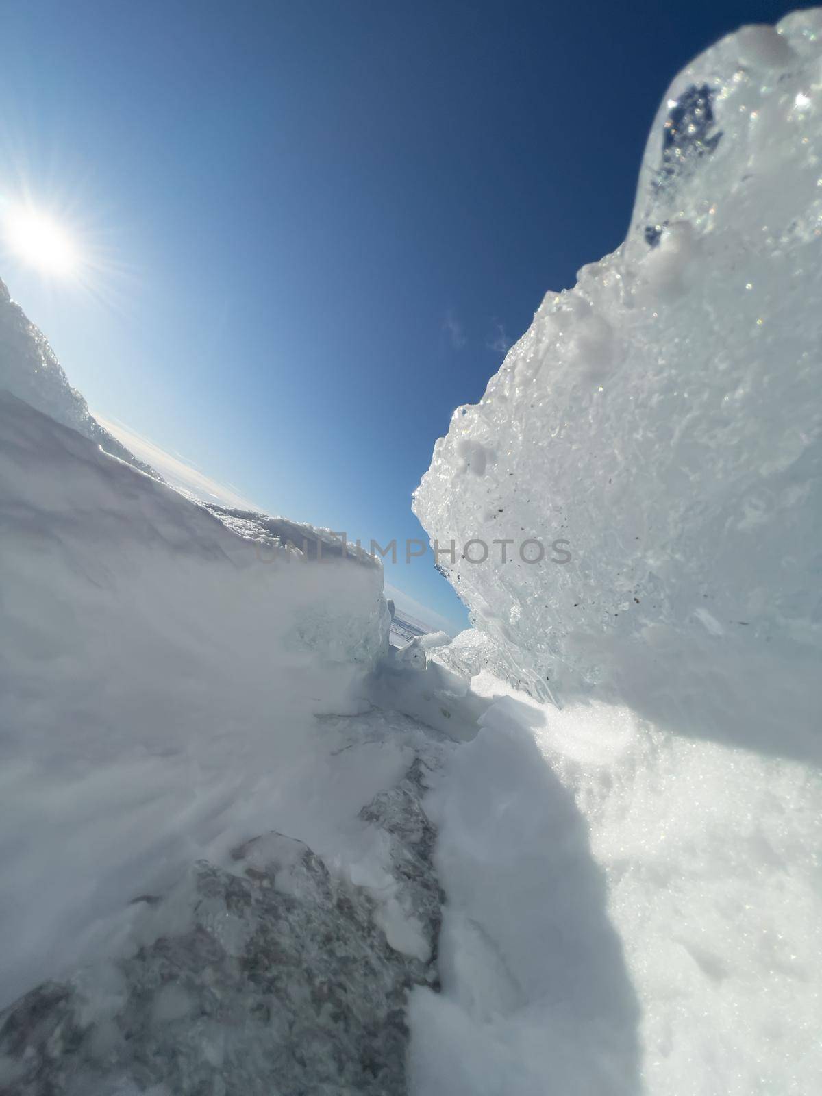 Ice slopes in sunny winter day, transparent ice of blue color, purely blue sky, long shadows, a pure snow-covered virgin soil, snow barkhans, by vladimirdrozdin