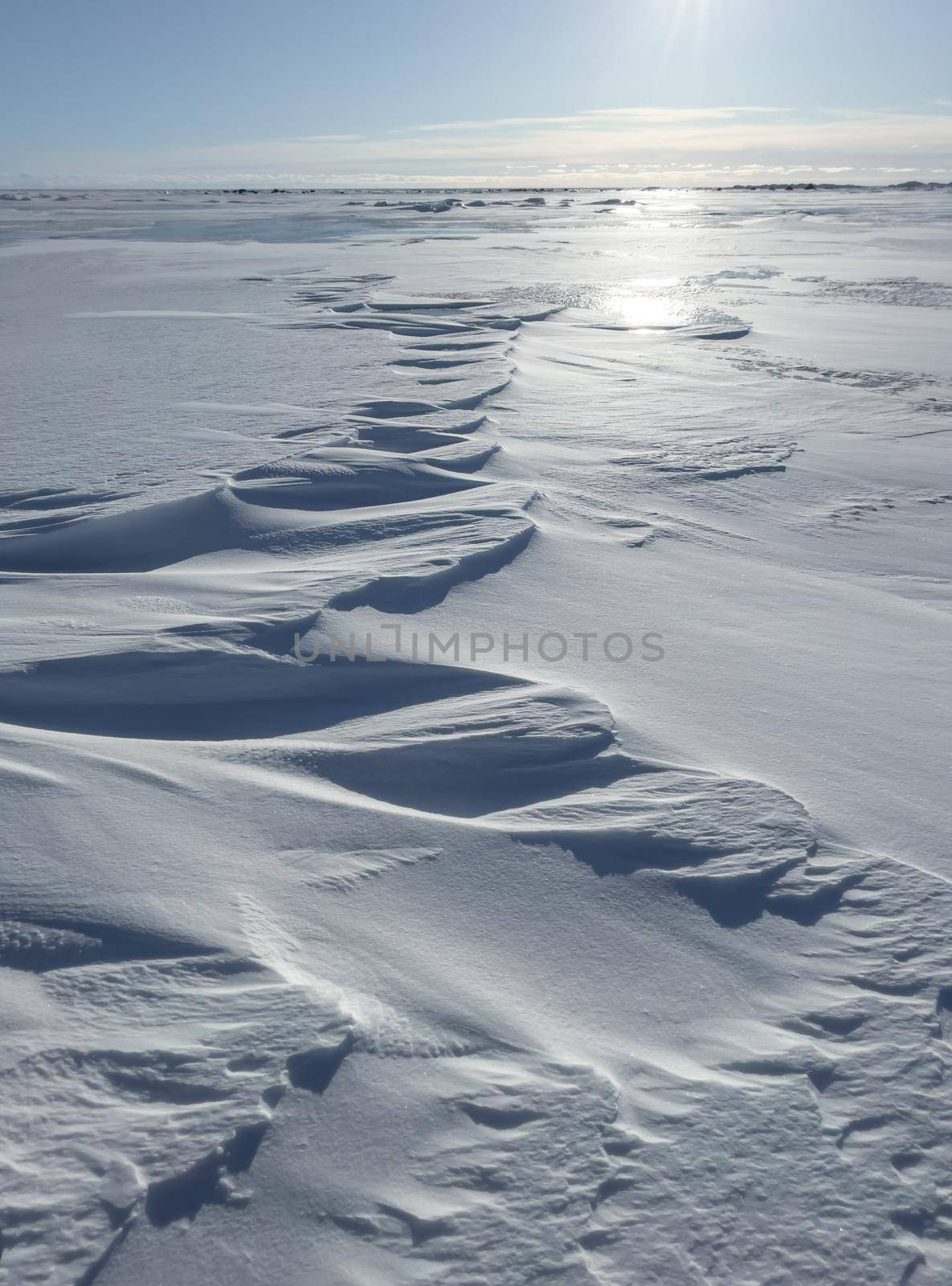 Ice slopes in sunny winter day, transparent ice of blue color, purely blue sky, long shadows, a pure snow-covered virgin soil, snow barkhans, by vladimirdrozdin