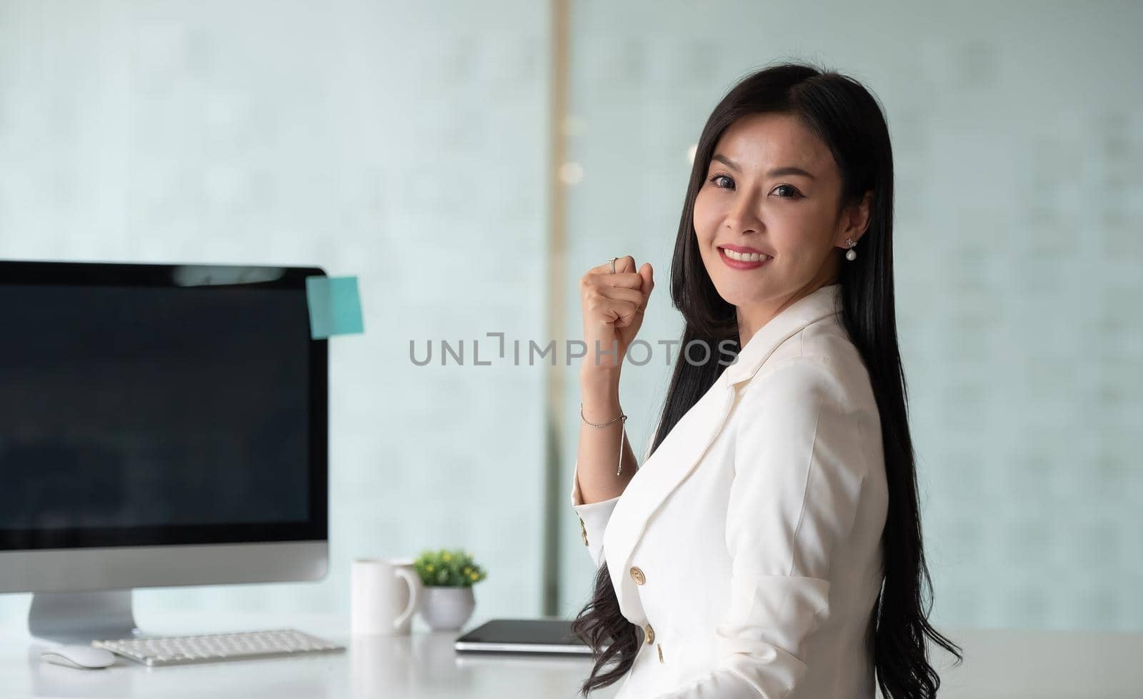 Portrait of excited business woman smiling and raised hands up celebrate , successful winner businesswoman look at camera.