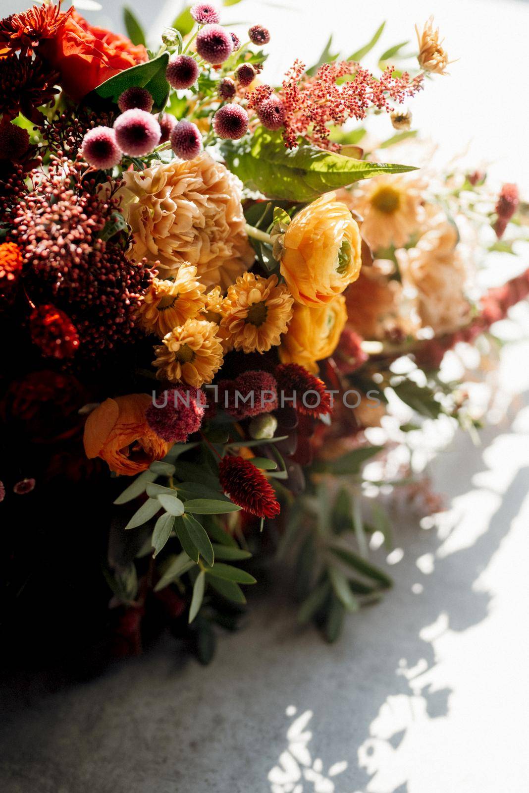 red elegant wedding bouquet of fresh natural flowers and greenery
