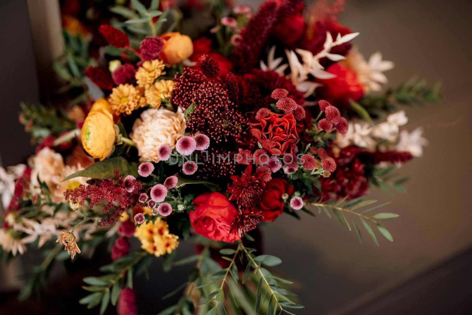 red elegant wedding bouquet of fresh natural flowers and greenery