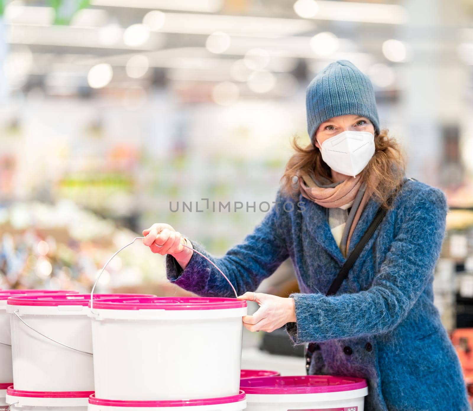Paint colors in the store. young woman shopping by Edophoto