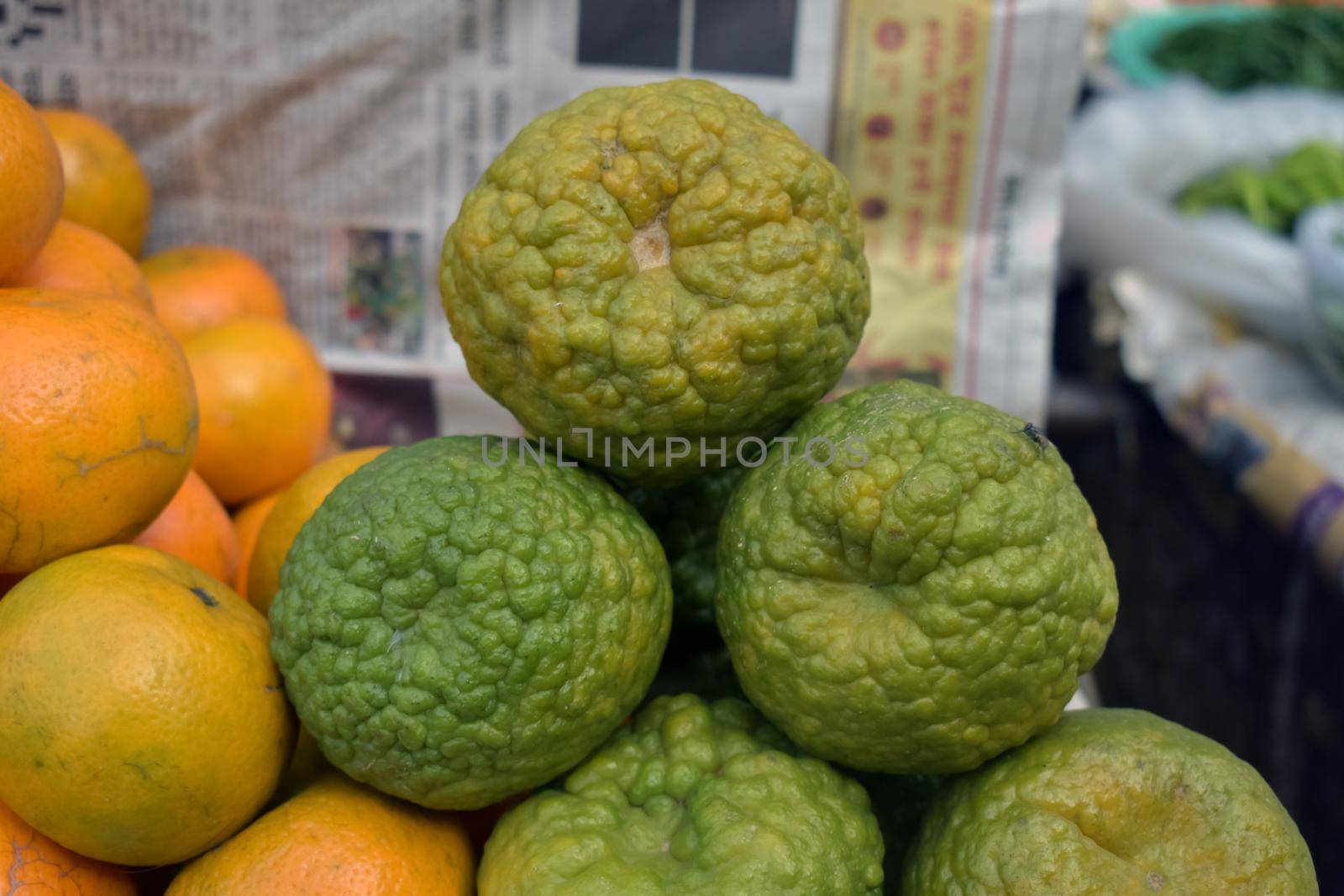 A closeup shot of a pile of fresh mandarin on a blurred background