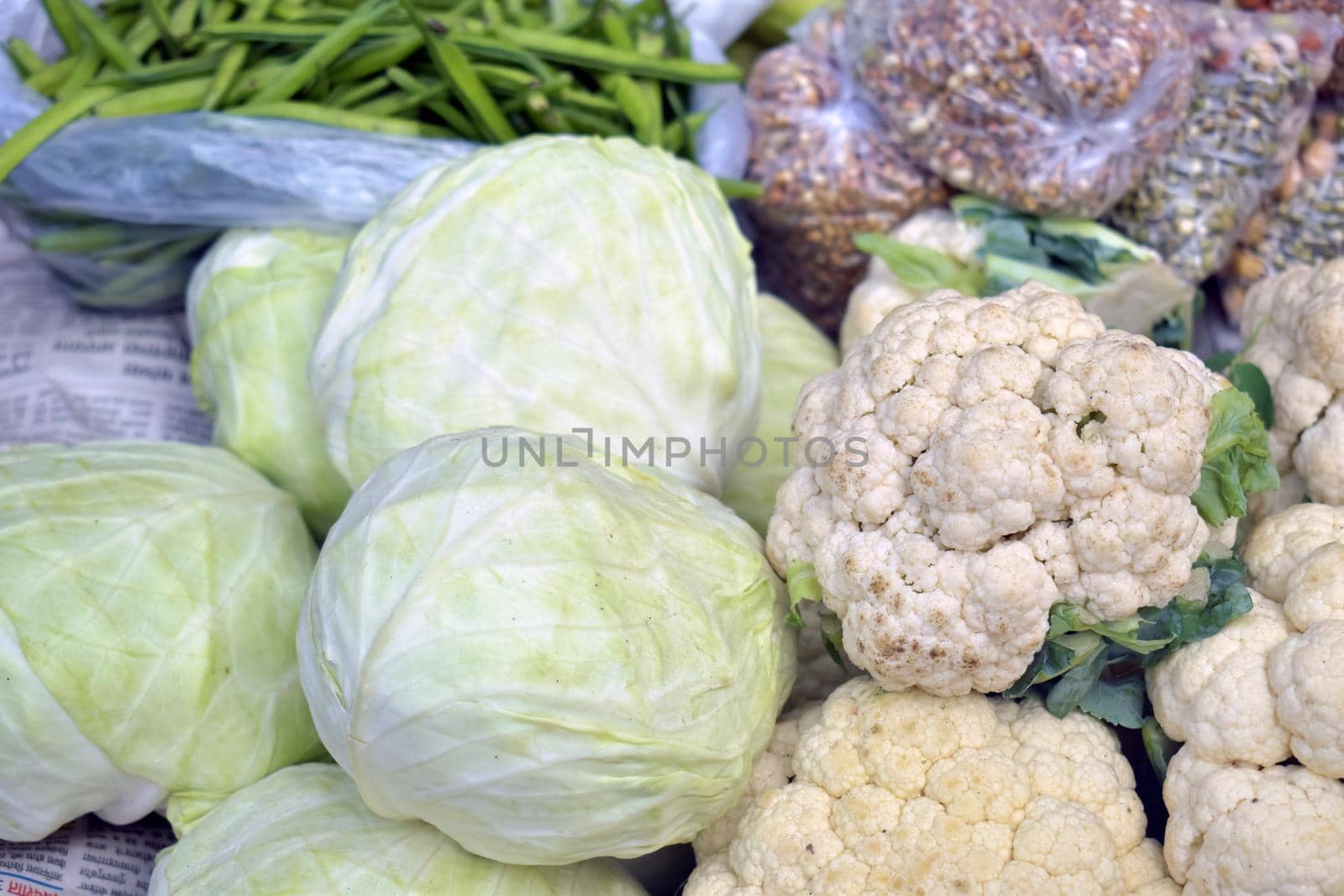 Closeup shot of cabbages and cauliflowers in a market place by tabishere
