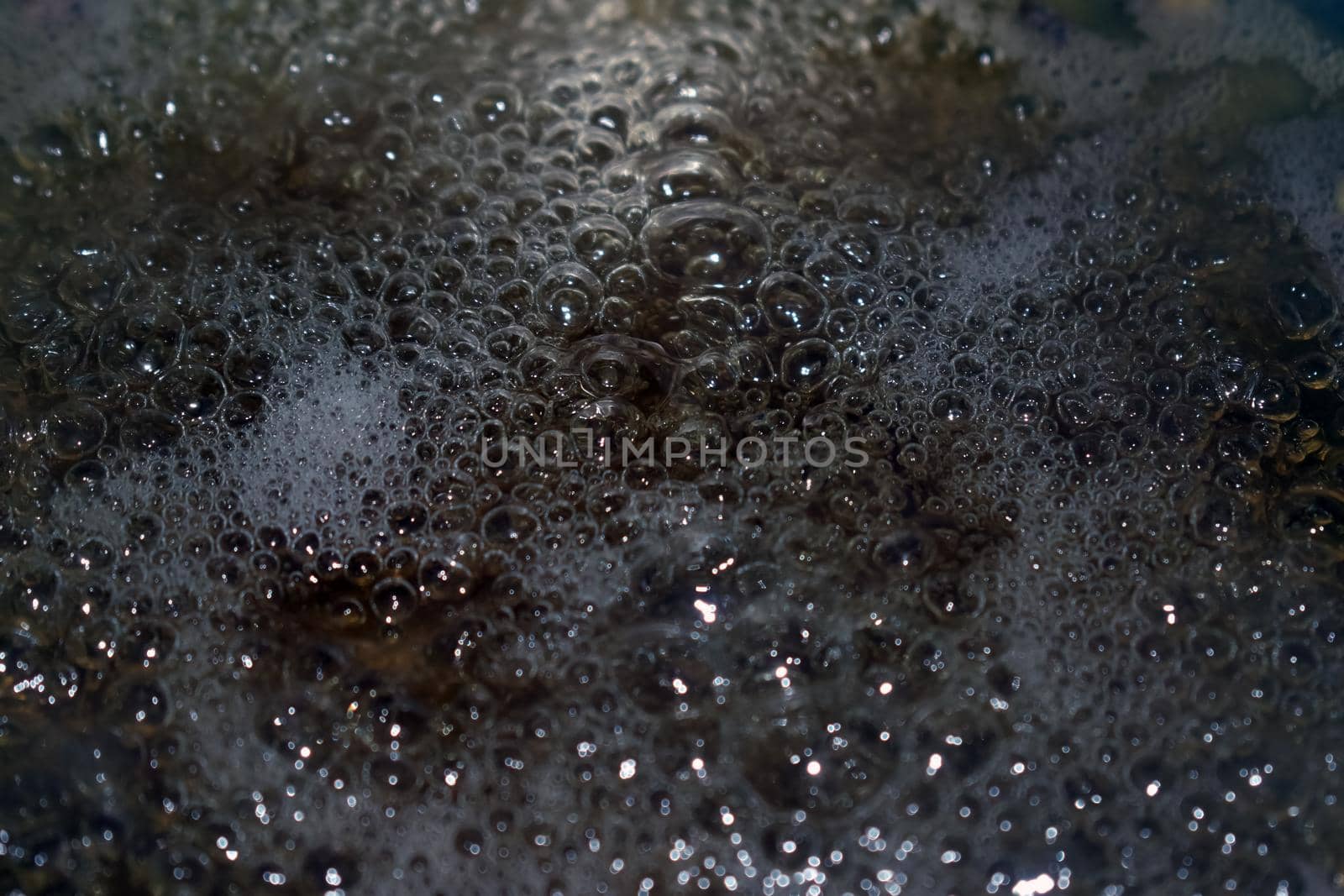 Closeup shot of bubbling boiling water by tabishere