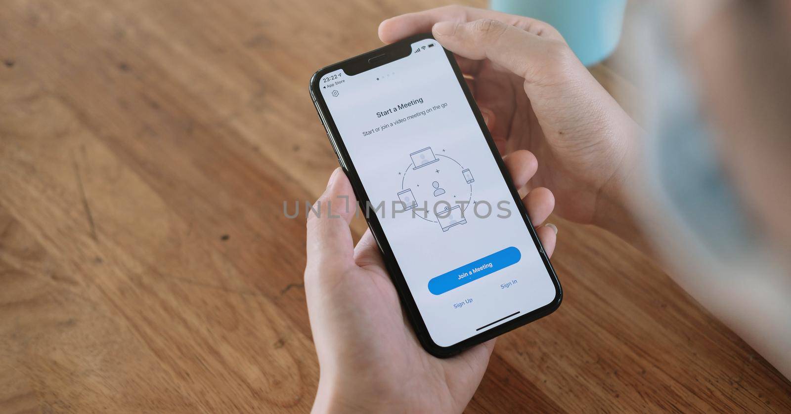 CHIANG MAI, THAILAND - JUN 14, 2020 : A working from home employee is downloading the Zoom application social platform, ready for internet meetings, remote workers or online education.