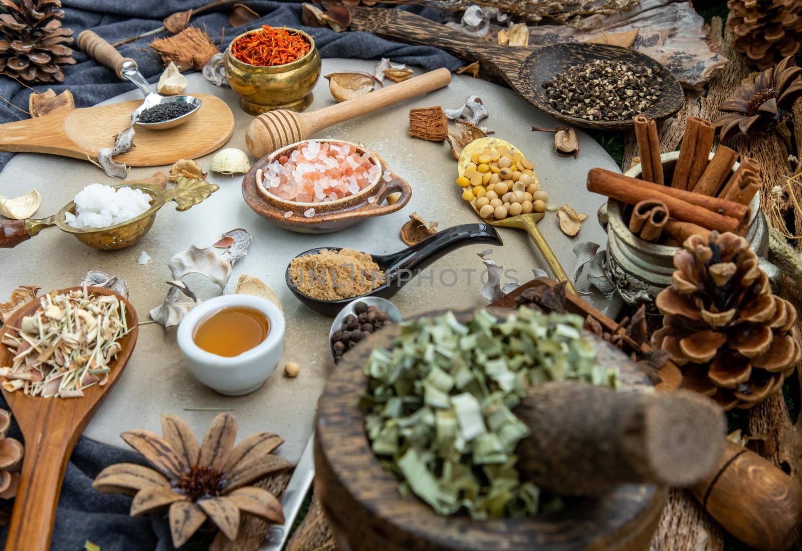 Various spices and herbs in rustic style with honey on balck background. Natural herbs medicine, Organic herbal and healthy concept, Selective focus.