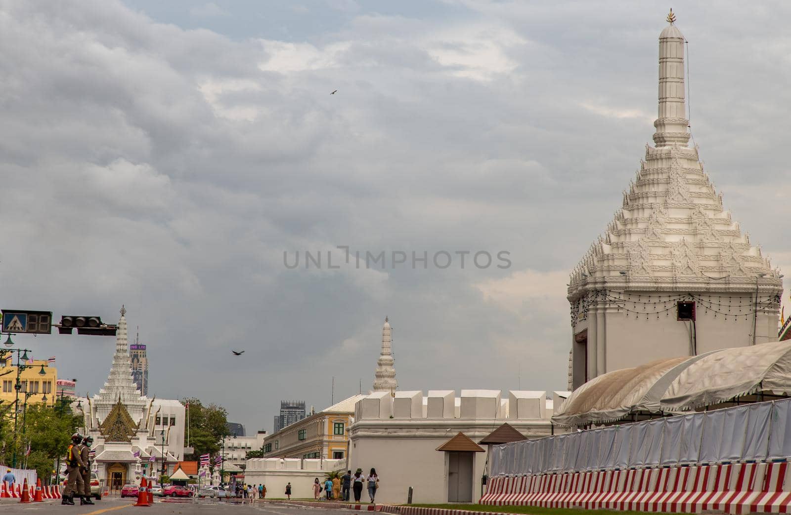 Bangkok, Thailand - Jun 19, 2020 : The road in front of Wat Phra Kaew (Temple of Emerald Buddha) and Grand Palace With a long white wall. And with the background of the sky in Bangkok.