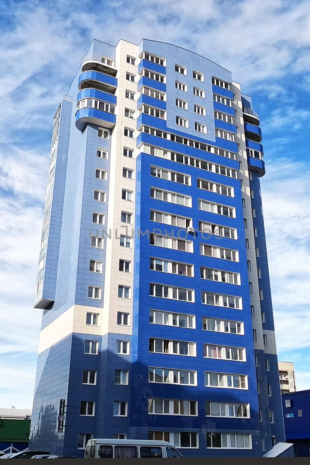 Multi-storey house against sky. Facade is blue. 20 floors. View from bottom up. by Essffes