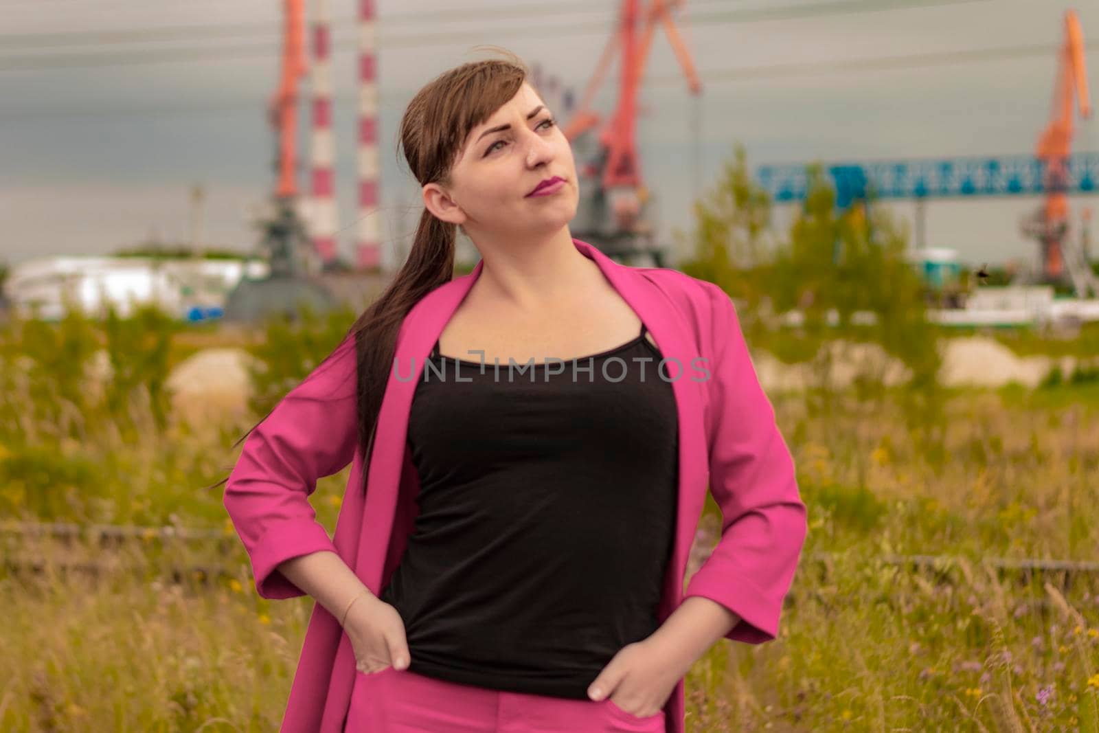 In a pink suit. Hands in your pockets. Portrait.