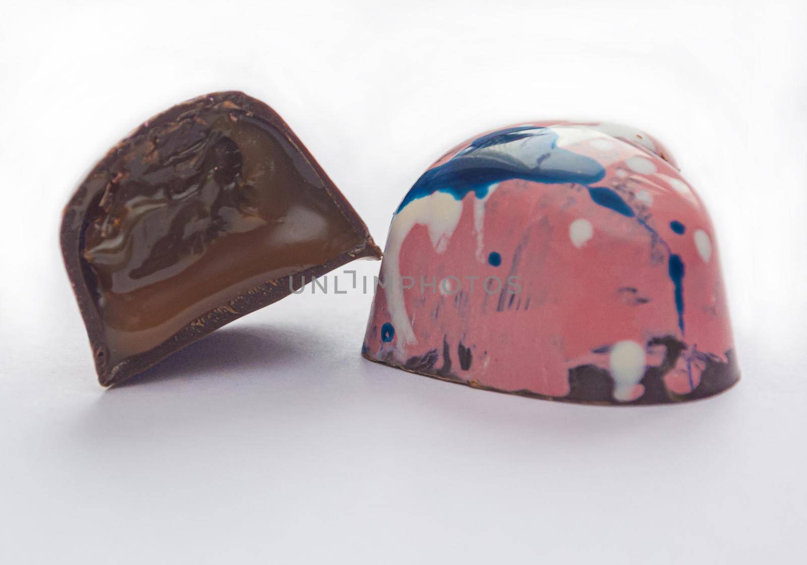 Tempered chocolate candies with a glossy painted body and fruit filling with blur elements by Grommik