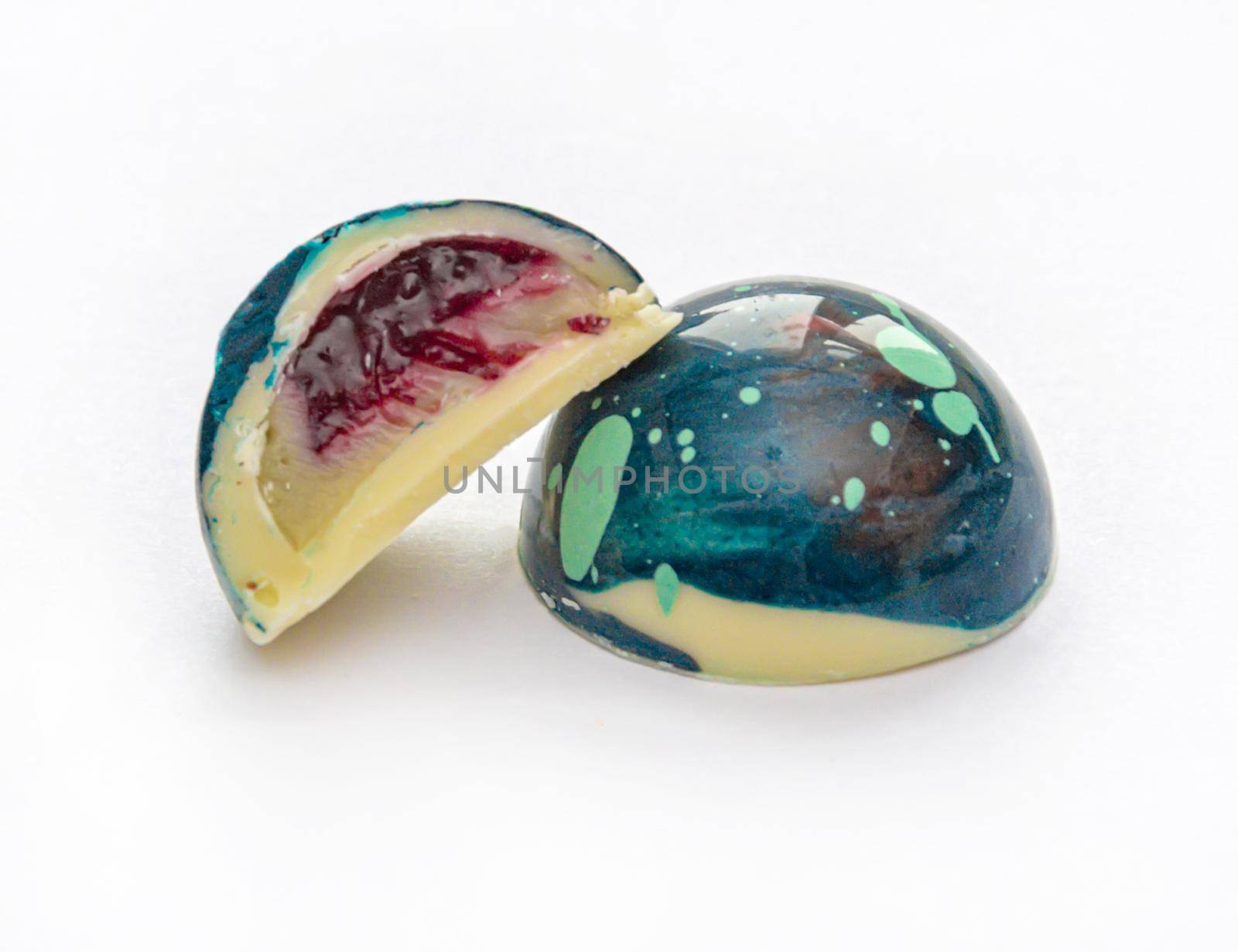 Tempered chocolate candies with a glossy painted body and fruit filling with blur elements by Grommik