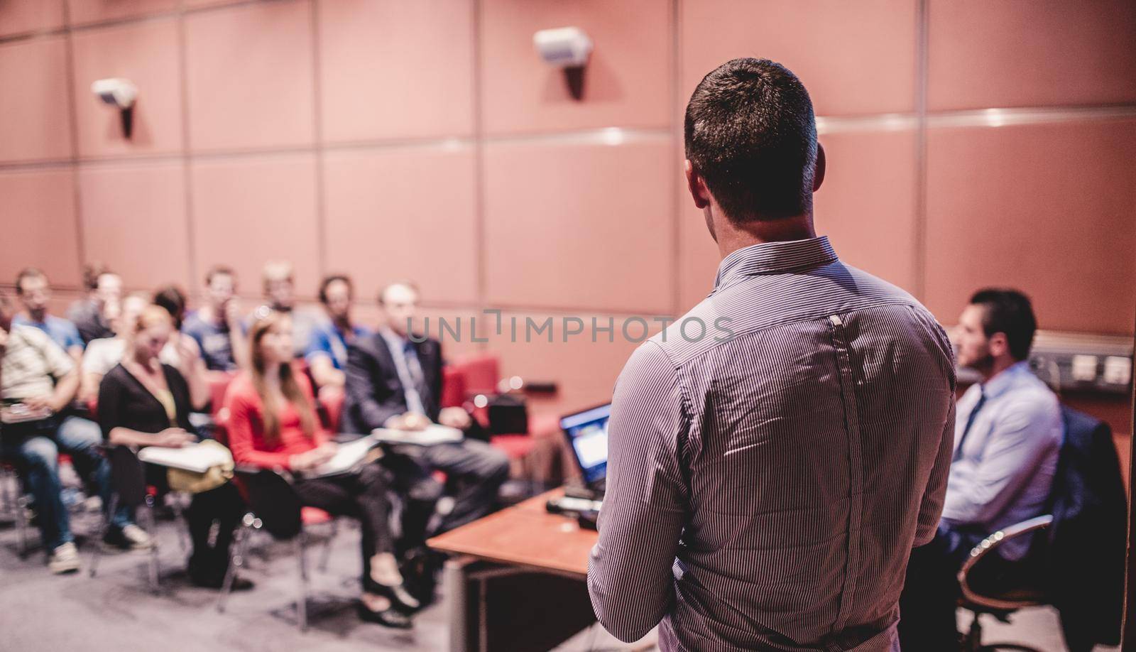 Speaker at Business Conference with Public Presentations. Audience at the conference hall. Business and Entrepreneurship concept. Background blur. Shallow depth of field.