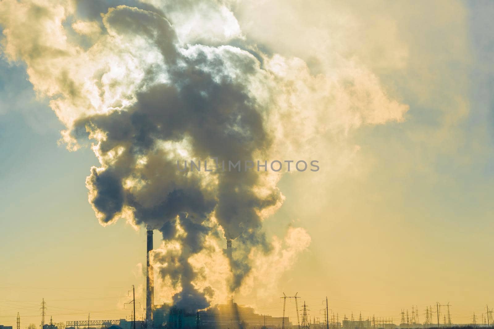 Smoking factory chimneys.Environmental problem of pollution of environment and air in large cities.Climate change,ecology and global warming.The sky is smoky with toxic substances.Soot from factories by YevgeniySam