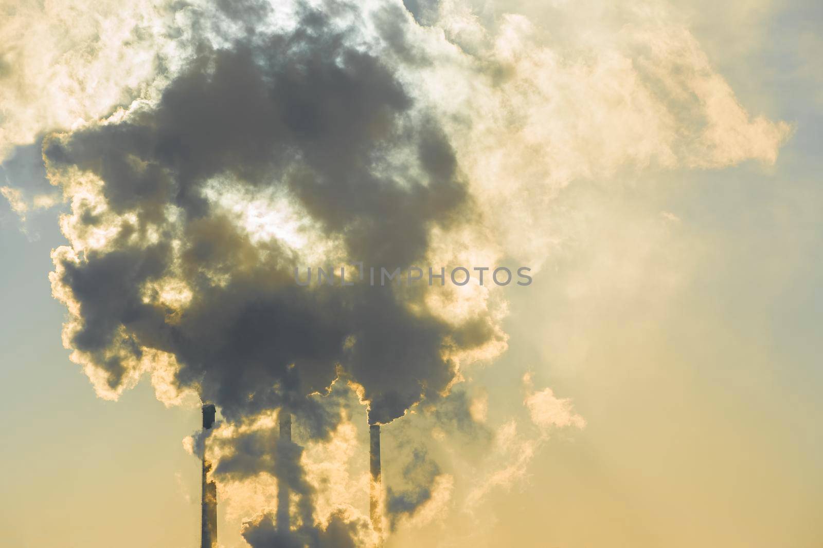 Smoking factory chimneys.Environmental problem of pollution of environment and air in large cities.Climate change,ecology and global warming.The sky is smoky with toxic substances.Soot from factories by YevgeniySam