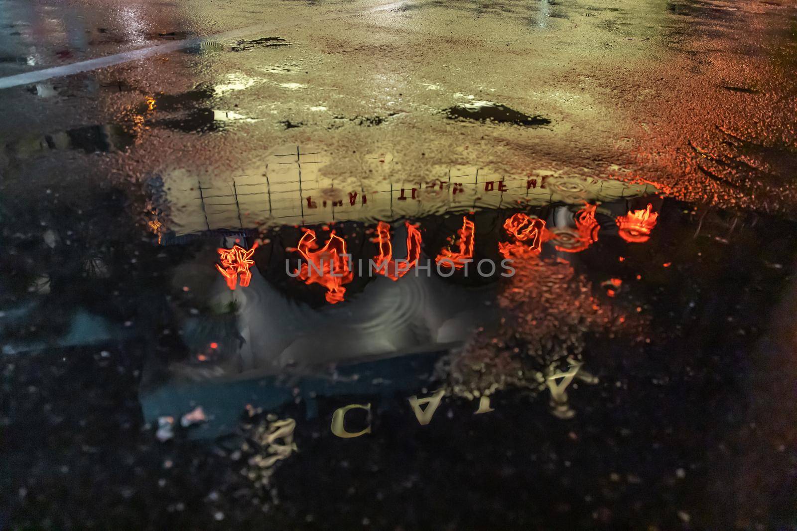 The reflextion of Scala cinema logo in water puddle after the rain.