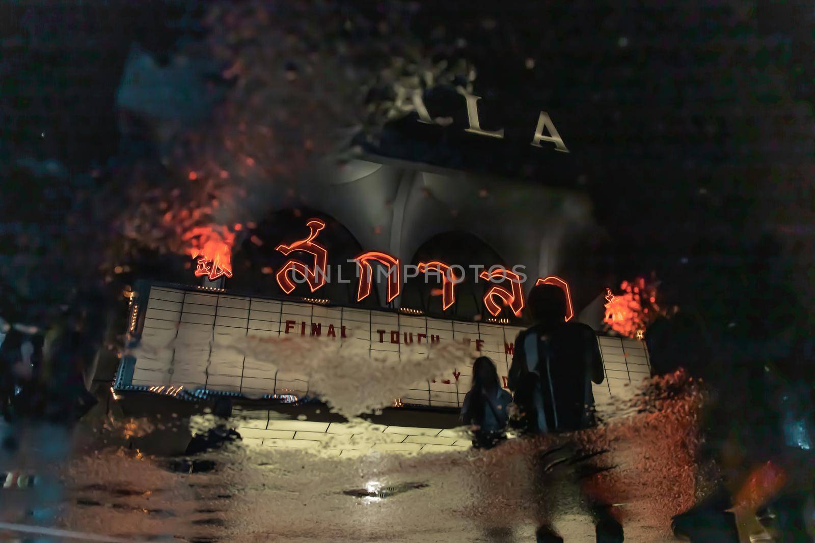 Bangkok, Thailand, Jul 03, 2020 : The reflextion of Scala cinema logo in water puddle after the rain.