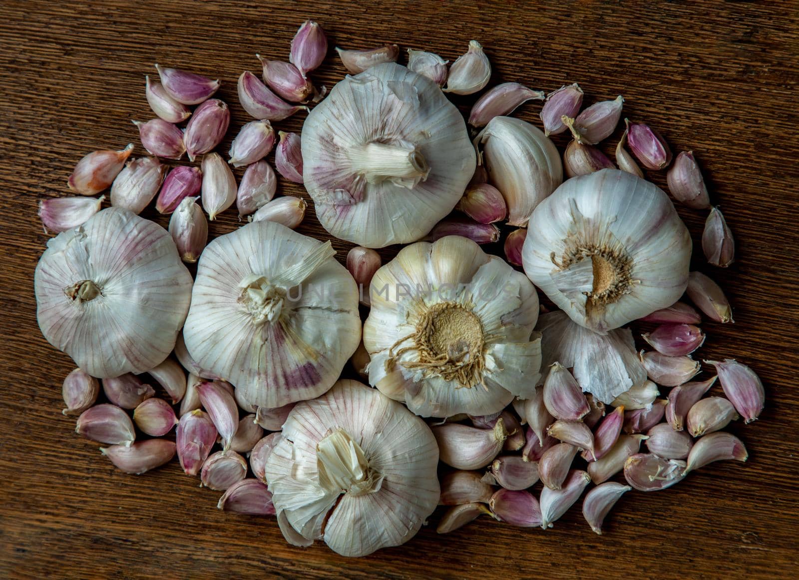 Garlic bulbs and Garlic cloves on Wooden rustic table. Copy space Concept of healthy food. Top view, Selective focus.