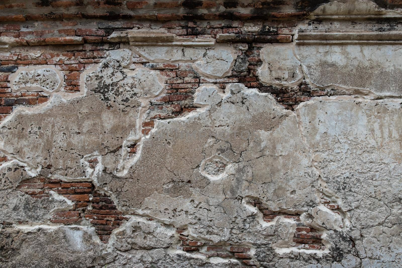 Cracked concrete vintage brick wall background. Archaeological area. Pattern on the wall with space for text, No focus, specifically.