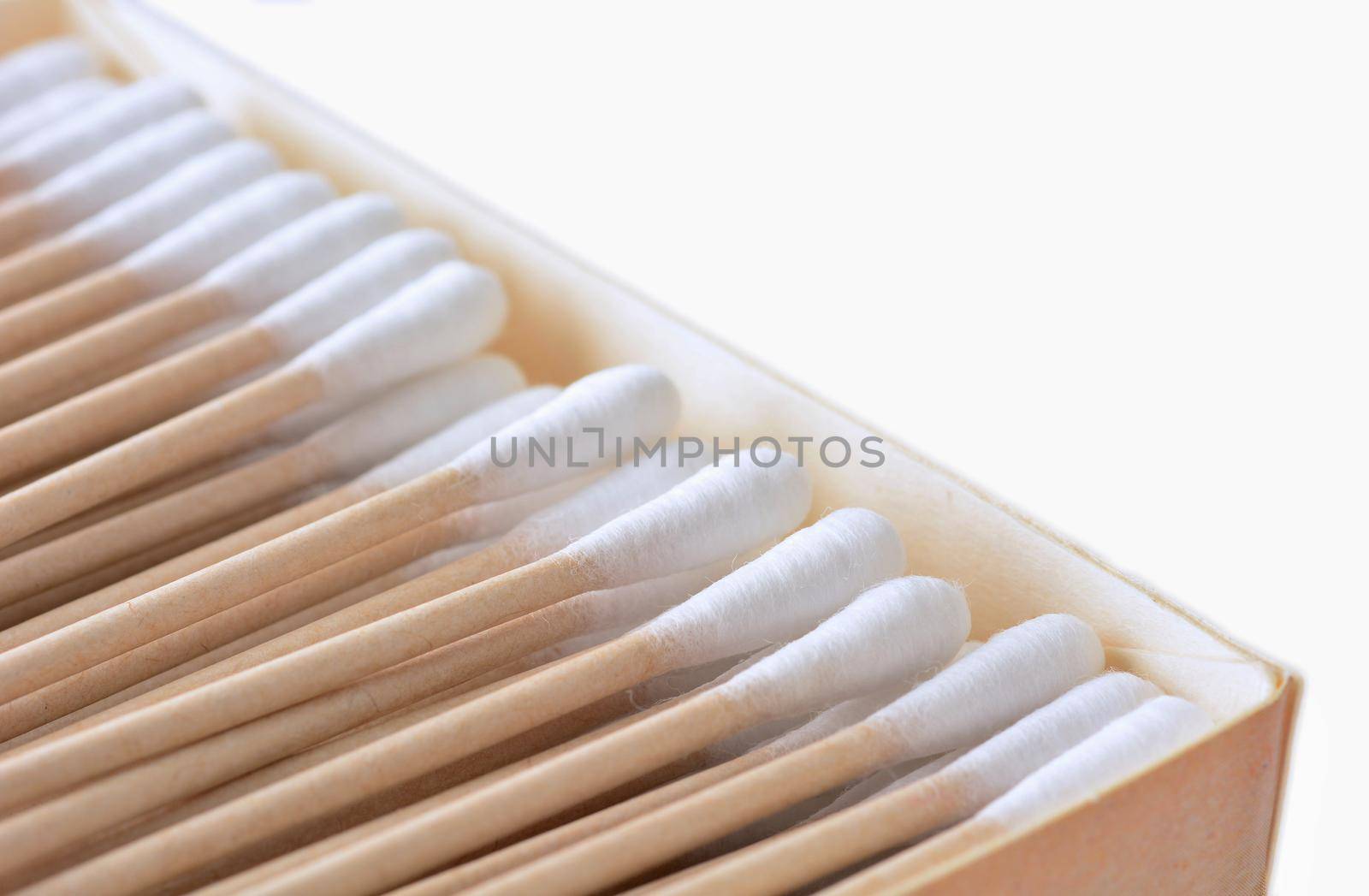 Box full of ecological paper cotton swabs on white background by hamik