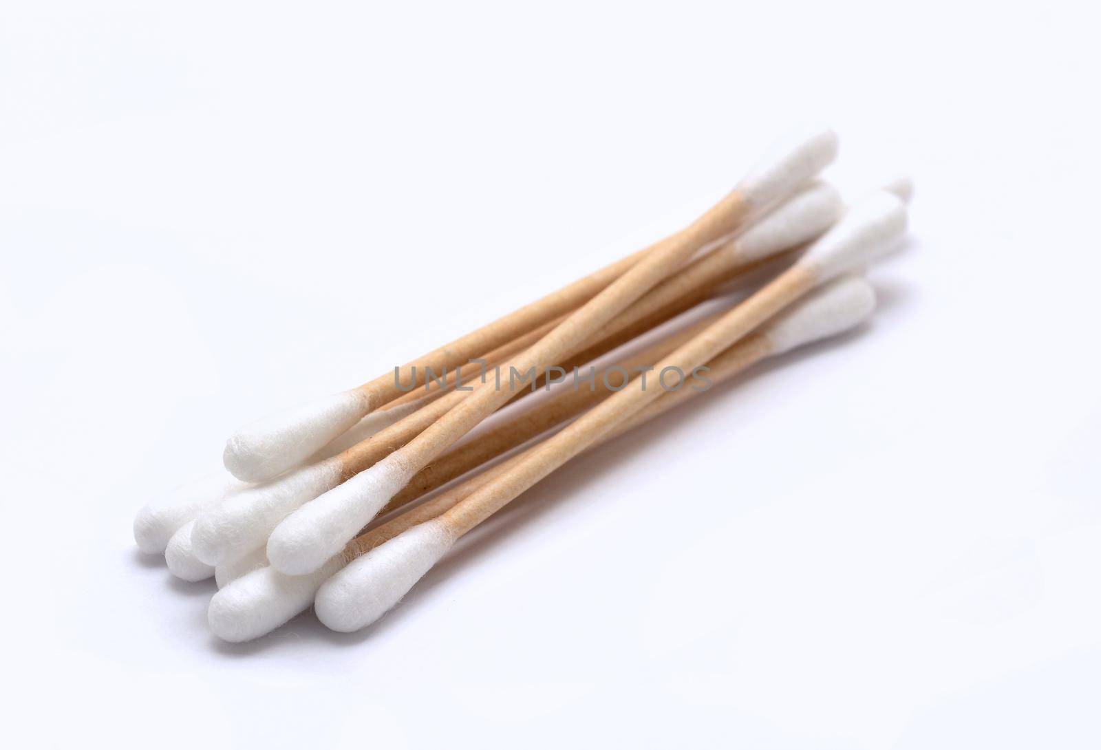 A heap of ecological recyclable cleaning cotton swabs from recycled paper. It used for better environmental conservation. Cotton swabs on white background.