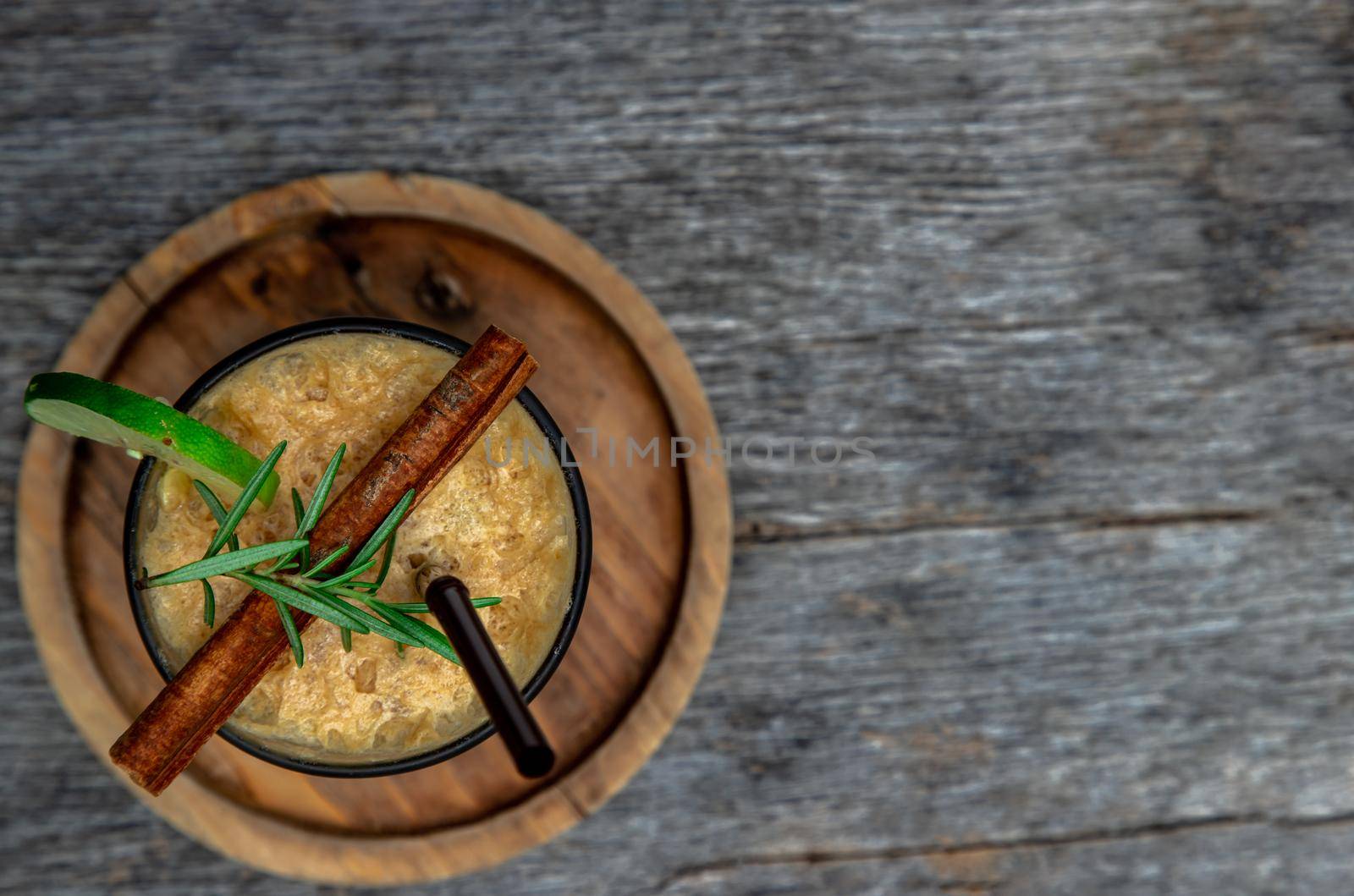 Honey lemon coffee. Close-up A glass of iced coffee mixed with honey and lemon on wooden background. Refreshing summer drink concept. Copy space, Selective focus.