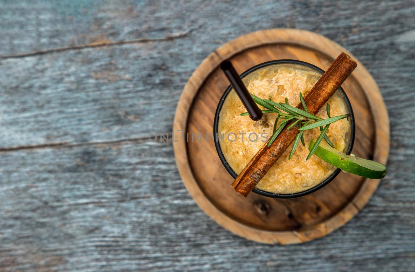 Honey lemon coffee. Close-up A glass of iced coffee mixed with honey and lemon on wooden background. Refreshing summer drink concept. Copy space, Selective focus.