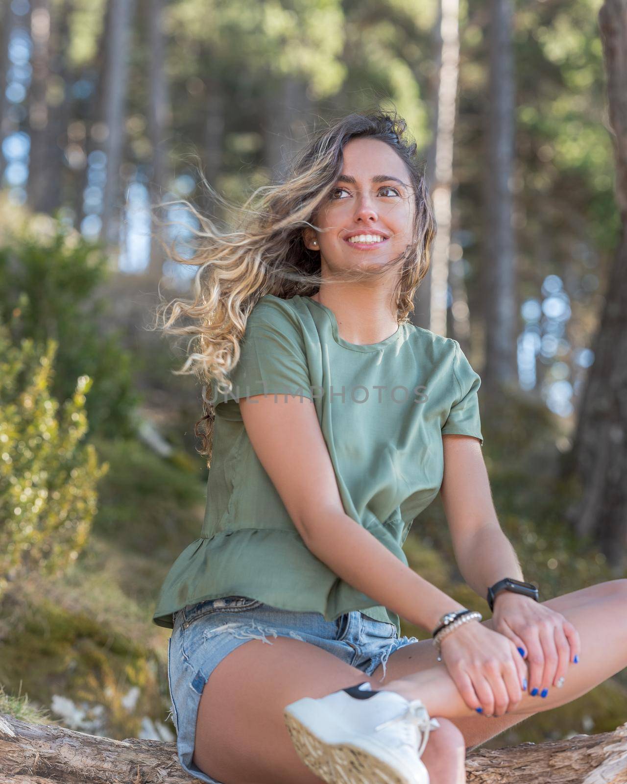 Pretty girl with curly hair in summer.