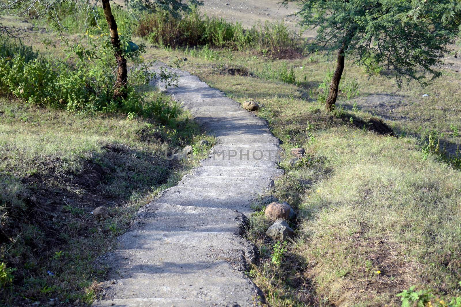 A view of a narrow stairway on a hill in a rural area, Long and narrow stone stairway on the rocky hill