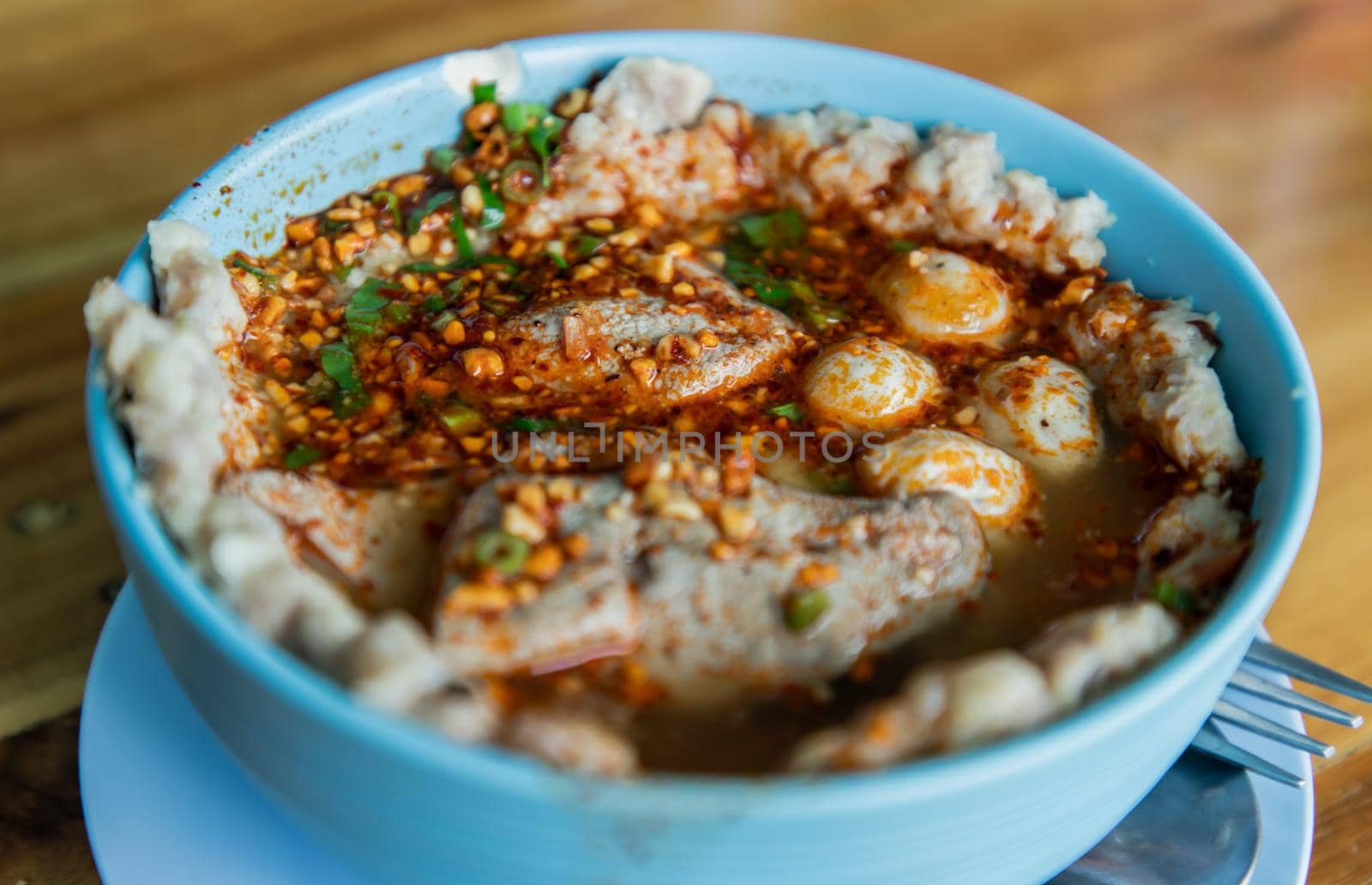 Close-up of Spicy tom yum pork soup or Spicy lemongrass flavored soup with pork. Focus and blur.