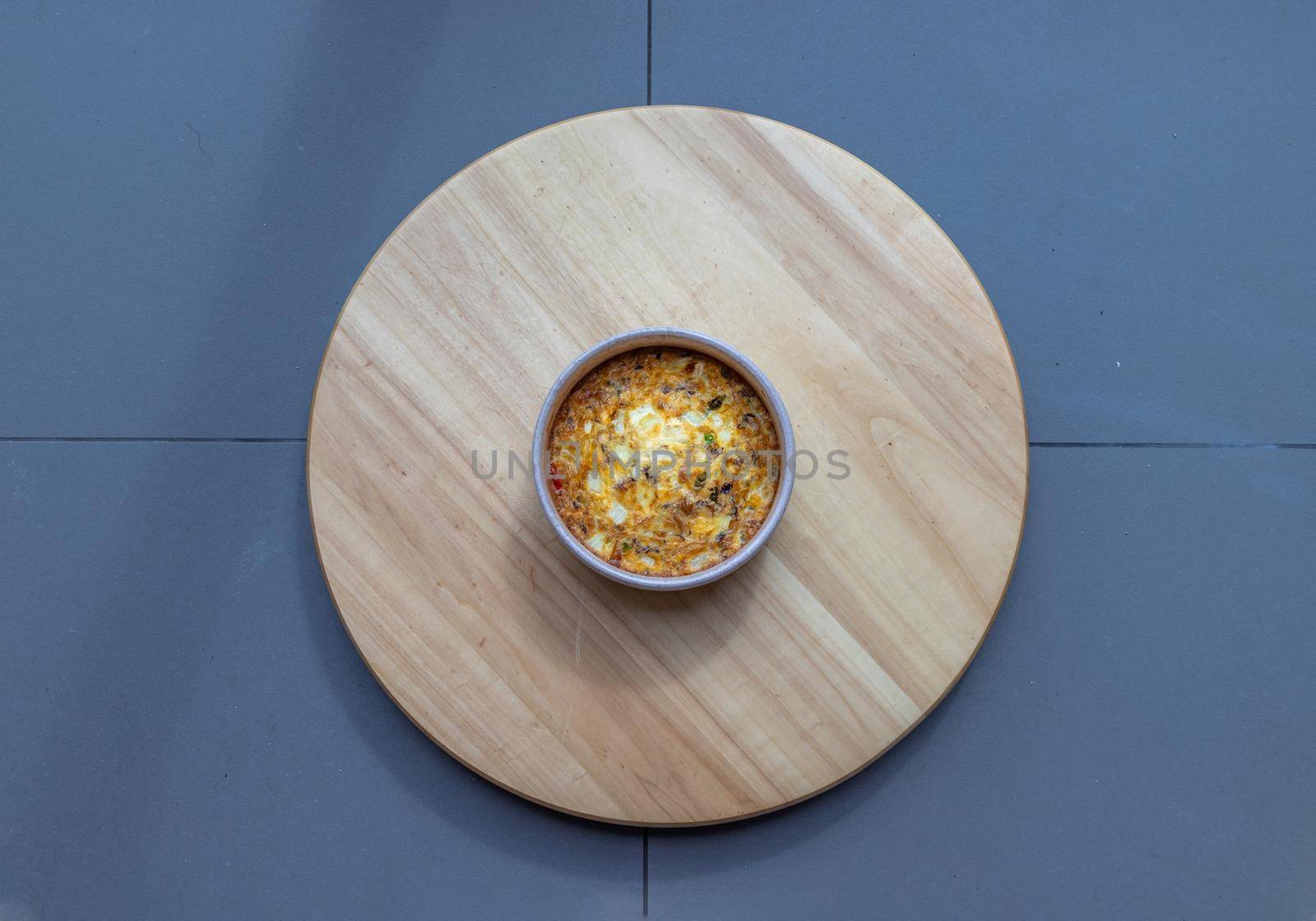 Baked eggs omelet on the wooden tray. Top view, Selective focus.
