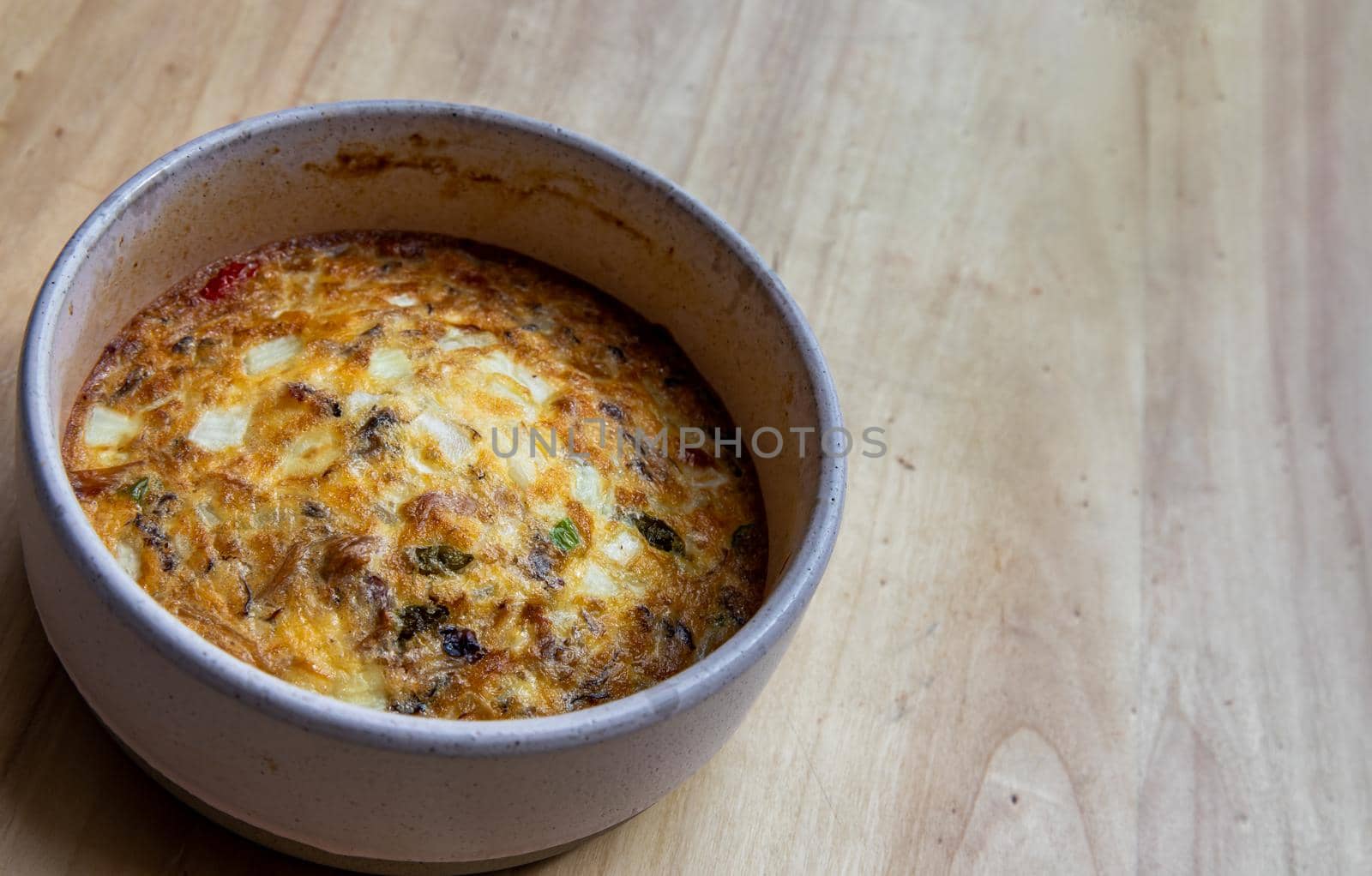 Baked eggs omelet on the wooden tray. Selective focus.