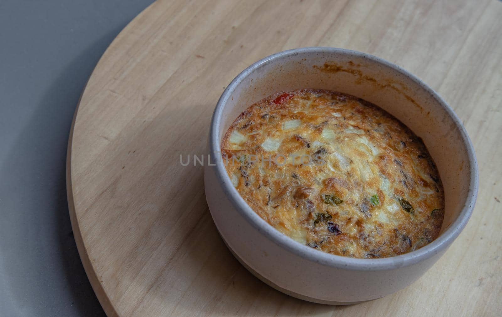 Baked eggs omelet on the wooden tray. Selective focus.