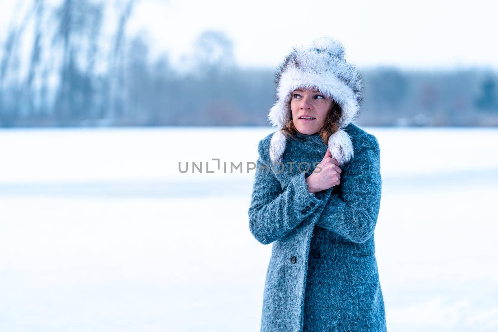 young freezing woman on winter icy lake. Banner. Copy space by Edophoto