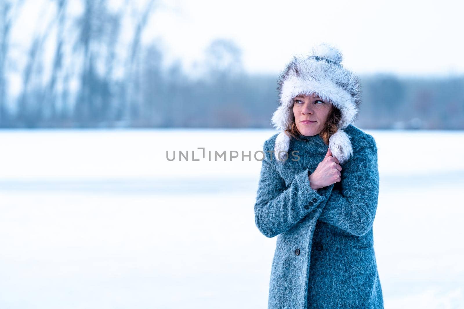 young woman in winter clothes in nature by Edophoto