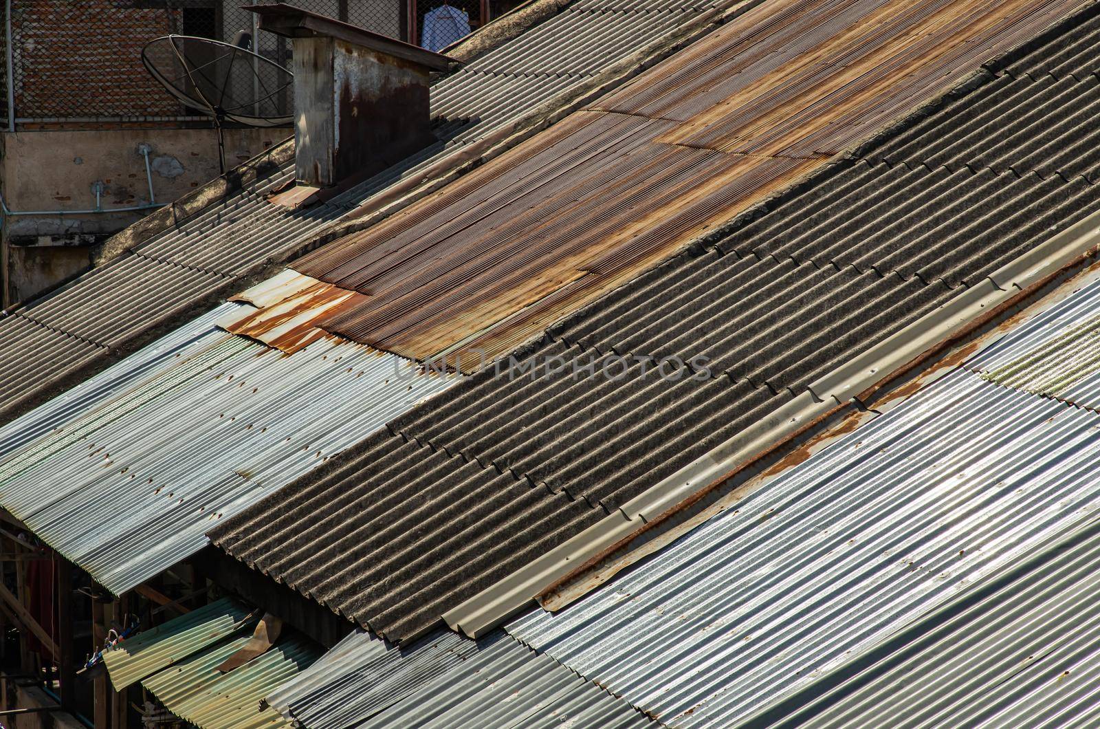 The Old galvanized roof and Old chimney roof on House, Old metal sheet roof texture, Rusty metal sheet texture. Selective focus.