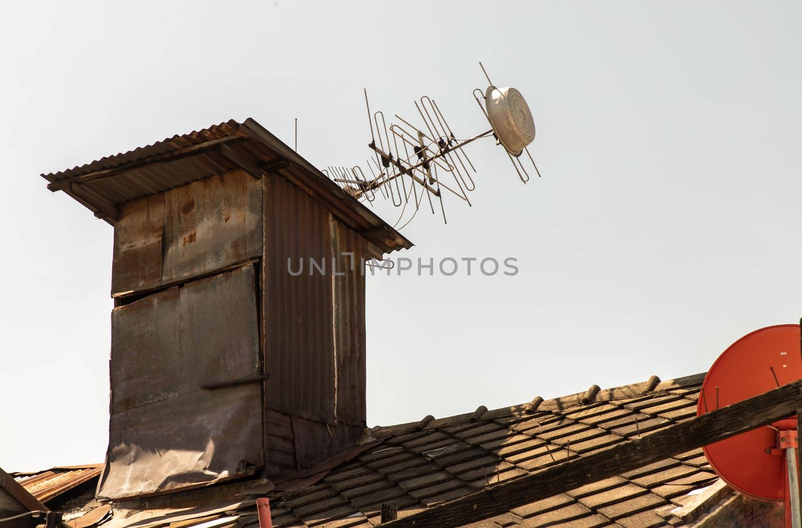 View of old chimney decay on old galvanized roof on white background. Selective focus